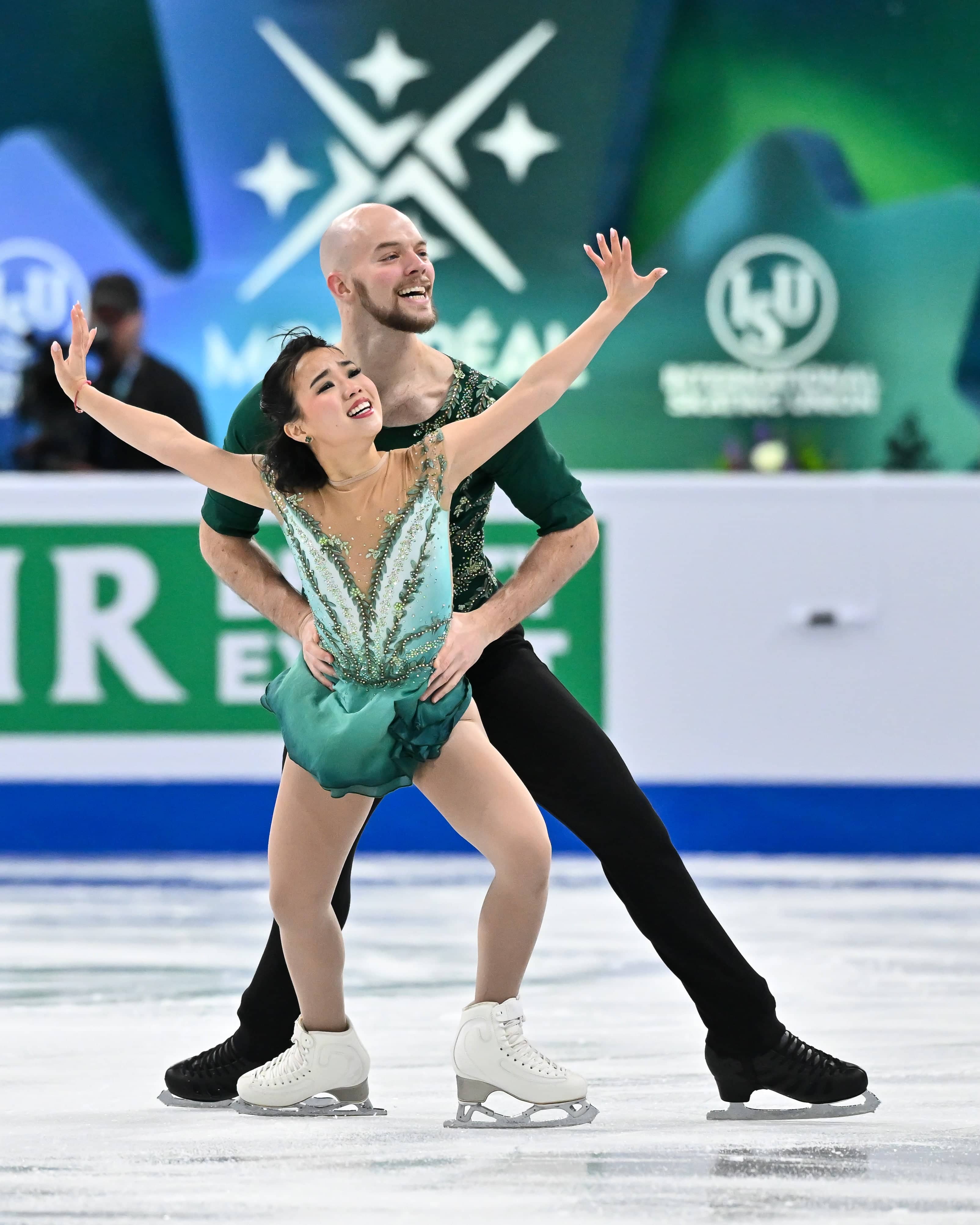 Dressed in all green, Ellie Kam skates in front of Danny O'Shea, dressed in black. 